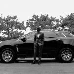 Business Man in a Suit Standing in Front of His Car
