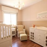 Crib, changing table, and other baby gear in a nursery