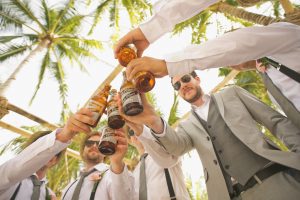 Group of Guys Toasting Beers at an Outdoor Party